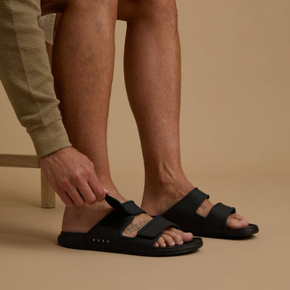 Oasis Adapt black men's sandals facing right, close-up of footbed and adjustable straps, comfort-focused design.