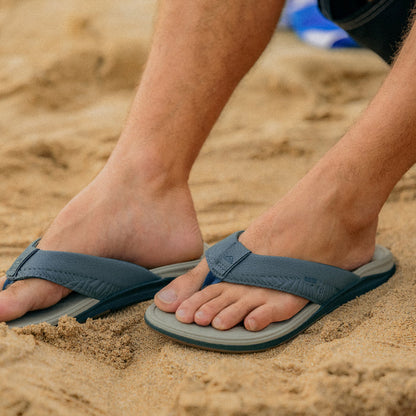 Offshore men’s sandals facing forward on sand, featuring water-friendly materials and anatomical arch support for comfort.