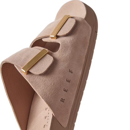 Ojai Two Bar women's sandal facing right, close-up on soft taupe suede upper with gold-tone buckles and embossed REEF logo