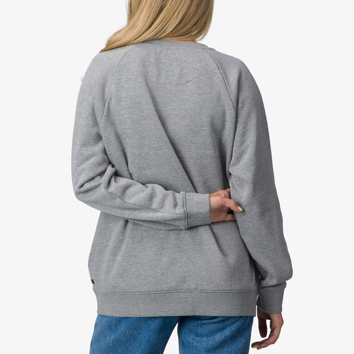Woman wearing Oversized Raglan Fleece in heather grey, back view, highlighting comfortable beach-inspired casual apparel.