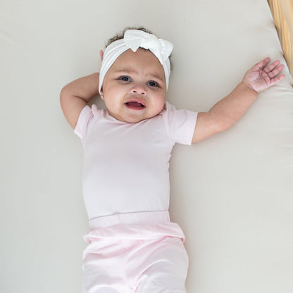 Infant wearing Kyte Baby Harem style Pant in Sakura
