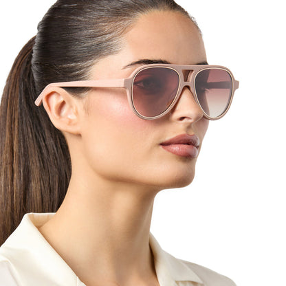 on model - female wearing iconica x diff eyewear pia oversized aviator sunglasses with a nude acetate frame and brown gradient polarized lenses angled view