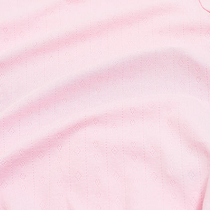 Close up of the pointelle fabric showing the light pink color