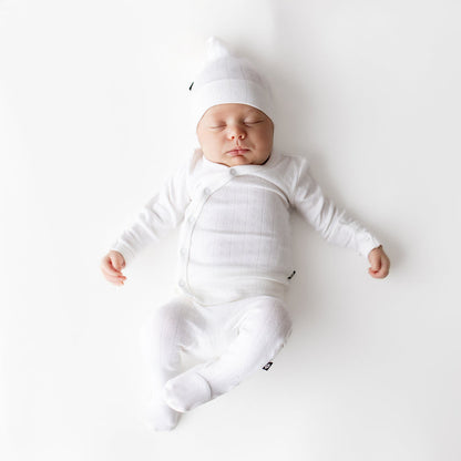 Sleeping newborn wearing the Pointelle Take Me Home Set with Cap in Cloud