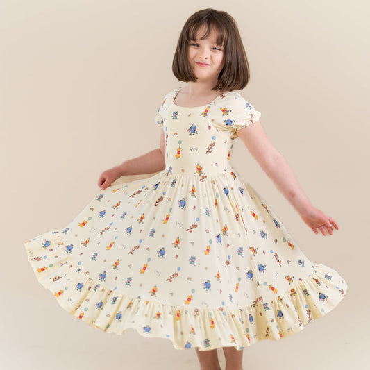 Young girl twirling wearing the Puff Sleeve Twirl Dress in Winnie the Pooh Celebration