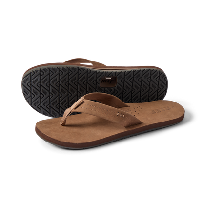 Reef Draftsmen men's brown sandals facing left with sole tread visible, featuring cushioned arch support and water-friendly design