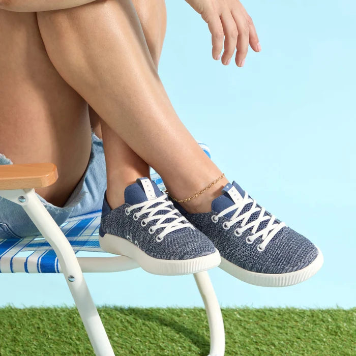 Reef Neptune women's navy sneaker facing right, close-up showing knit upper and cushioned sole for beach comfort.