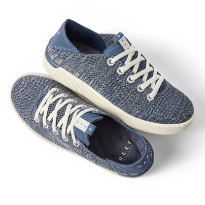 Pair of Reef Neptune women's sneakers shown from the top and right side in blue knit with white laces, designed for comfort and beach wear.