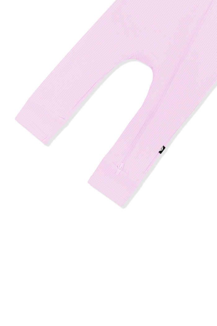 Close up of the zipper on the leg of the Ribbed Zipper Romper in Thistle