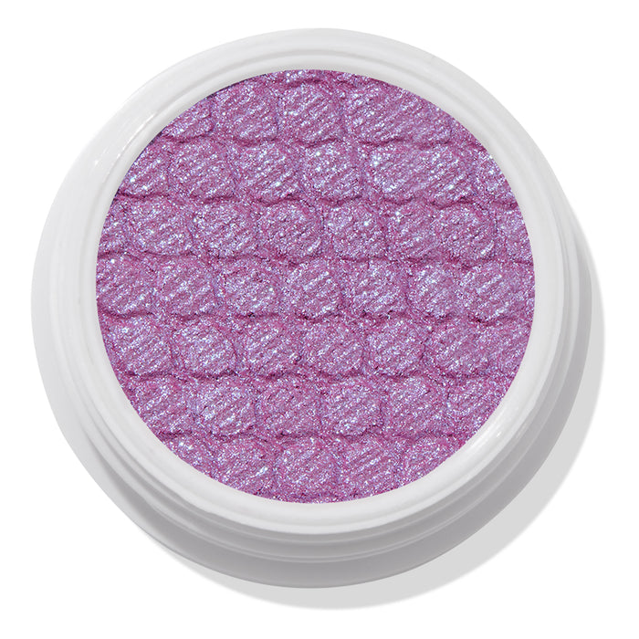 ColourPop Ripple Super Shock Shadow, a shimmering lavender eyeshadow with blue-violet sparkle, fills a textured quilted pan in a round white pot, shown top-down on a clean white background.