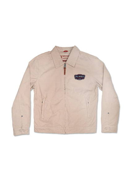 Beige zip-up jacket with collar, patch logo on chest, and buttoned cuffs, laid flat on a white background.