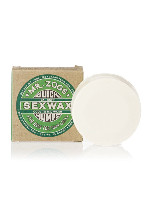 Mr. Zog's Sex Wax package with a round bar, labeled "Cool to Mid Warm," for surfboards. Green and brown design.