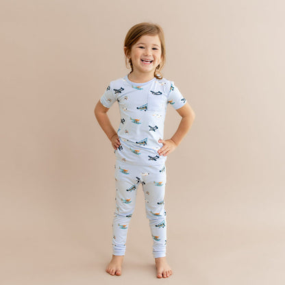 Young girl standing with her hands on her hips wearing the Short Sleeve with Pants Pajamas in Take Off