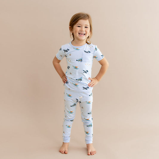 Young girl standing with her hands on her hips wearing the Short Sleeve with Pants Pajamas in Take Off