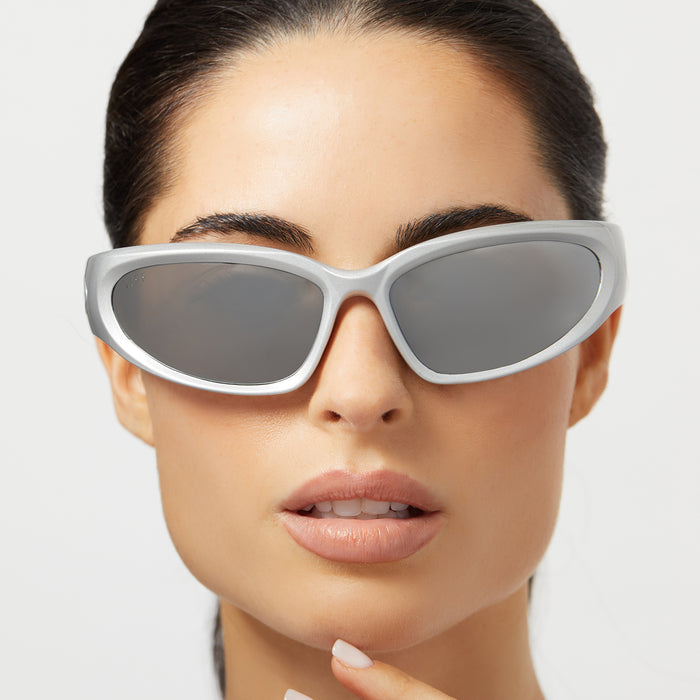 on model - female wearing diff sport side out wrap sunglasses with a silver frame and silver mirror polarized lenses front view