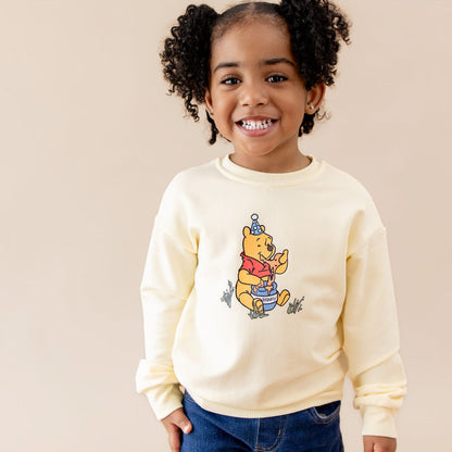 Close of up of the Sweatshirt in Winnie the Pooh on Chamomile shown on a young girl
