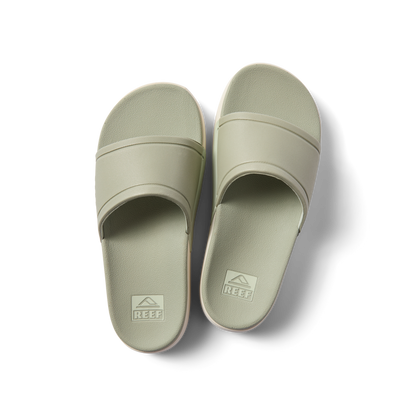 Pair of sage green Sydnee Cutback Low slides facing upward, showcasing comfort-focused footbed and water-friendly design.