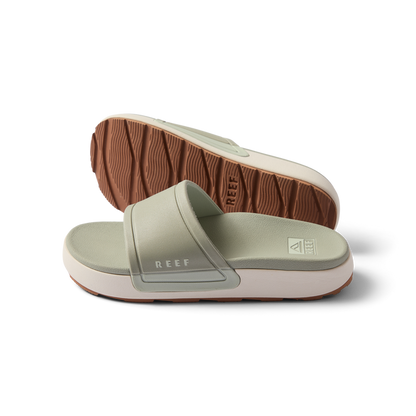 Pair of women's Sydnee Cutback Low slides in sage facing right, showing top and sole with textured brown outsole.