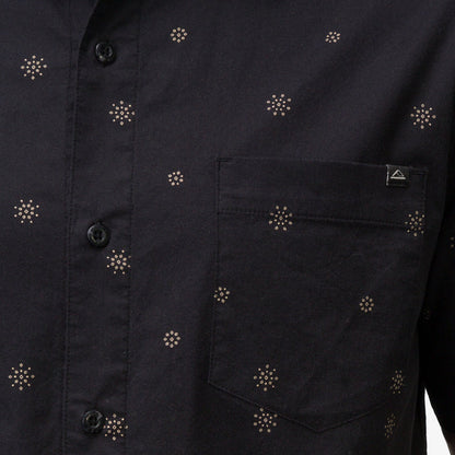 Close-up of the pocket and button area on the men's Topaz Shirt featuring subtle patterned dots on black fabric.