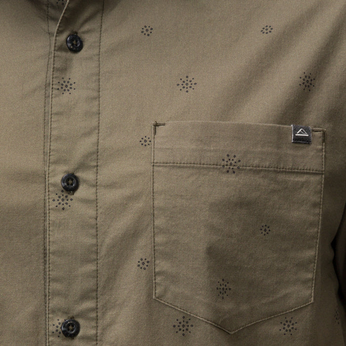 Close-up of the olive green Topaz Shirt pocket with subtle dot pattern and black buttons, beach-inspired comfort apparel.