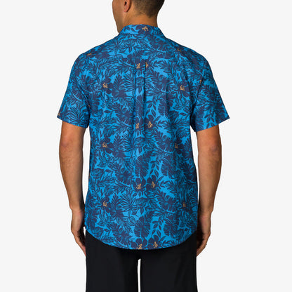 Man wearing Tyson Classic Shirt showing back view with blue tropical leaf pattern, beach-inspired comfort apparel for men.