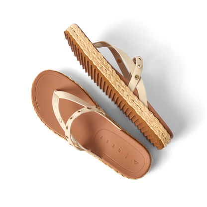 Vista Carmen women's sandals with ivory straps, rivet accents, and textured sole, angled side and top views, beach-inspired comfort.
