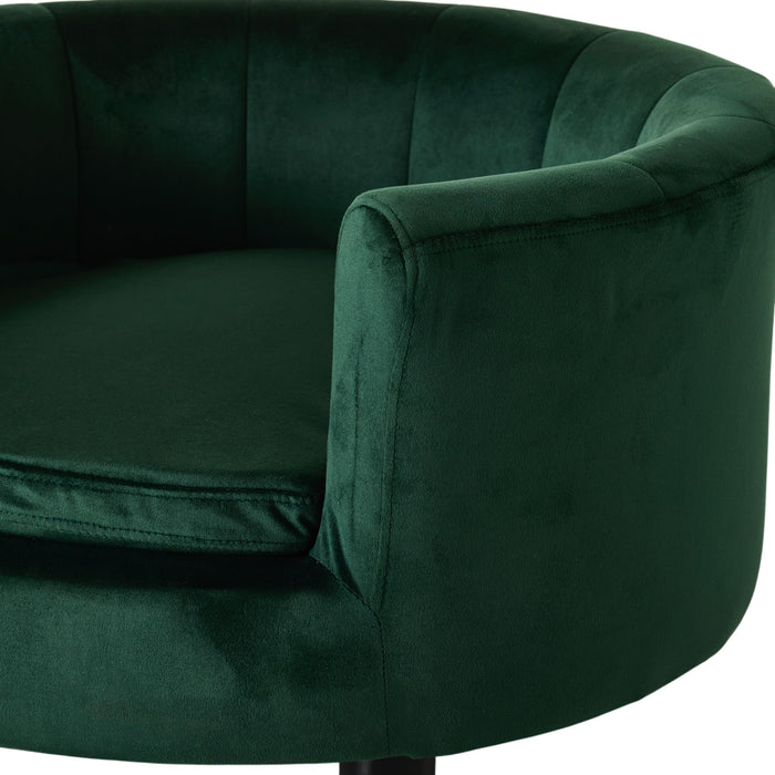 Close-up of the Vivienne Velvet Pet Bed in Forest, featuring plush deep green upholstery, a rounded back, cushioned seat, and elevated modern design. Size: 65x65x36cm.
