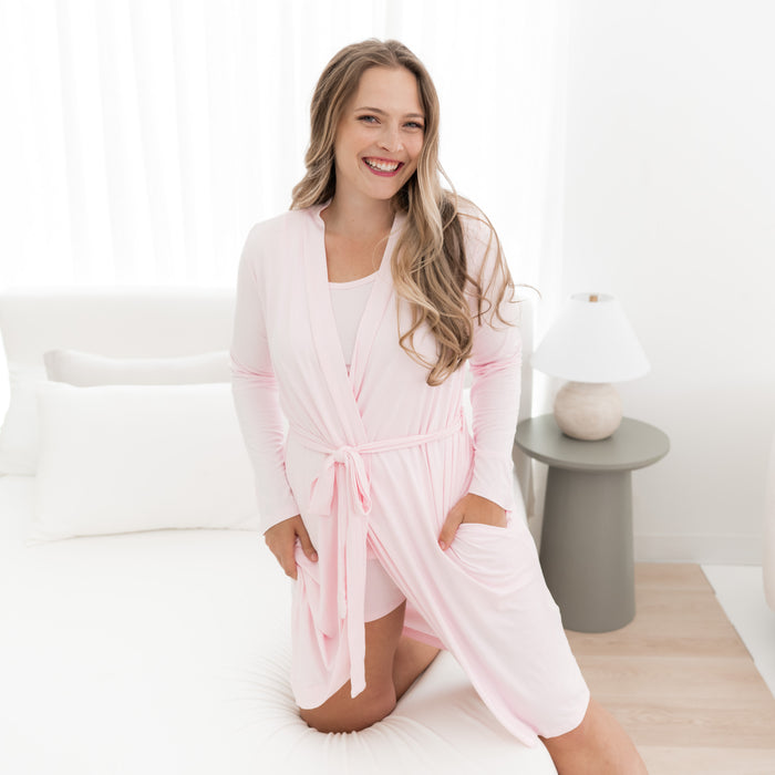 Woman modeling Women’s Lounge Robe in Sakura on bed