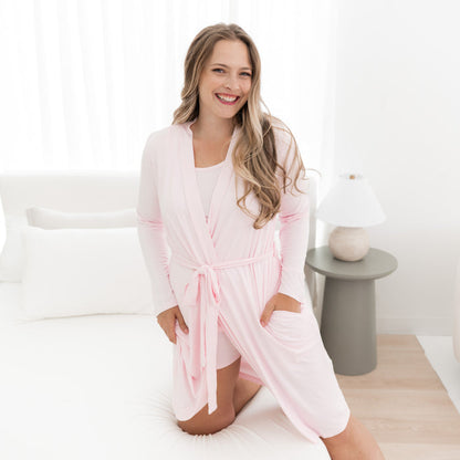 Woman modeling Women’s Lounge Robe in Sakura on bed
