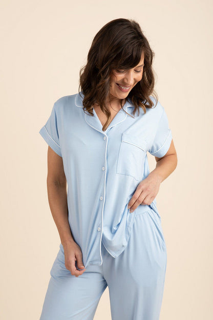 Female posing wearing the Women's Short Sleeve Cropped Pajama Set in Breeze standing in front of a light beige background