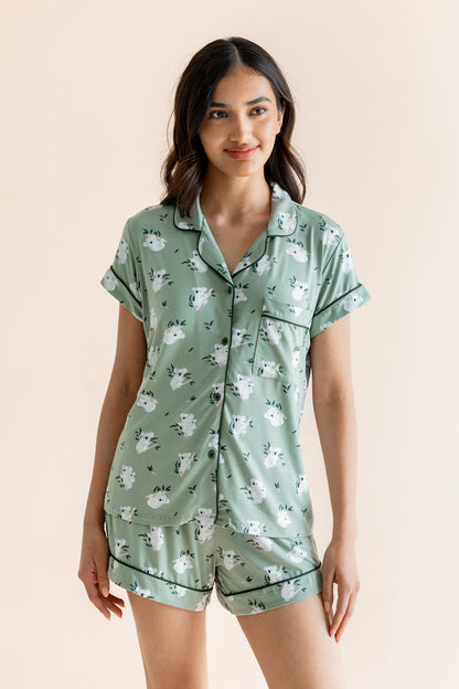 Model wearing Women's Short Sleeve Pajama Set in Koala print on beige background