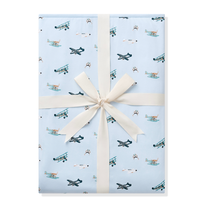 Youth Blanket in Take Off 1.0 shown wrapped in its packaging tied with a linen bow