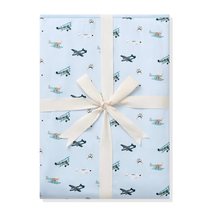Youth Blanket in Take Off 1.0 shown wrapped in its packaging tied with a linen bow